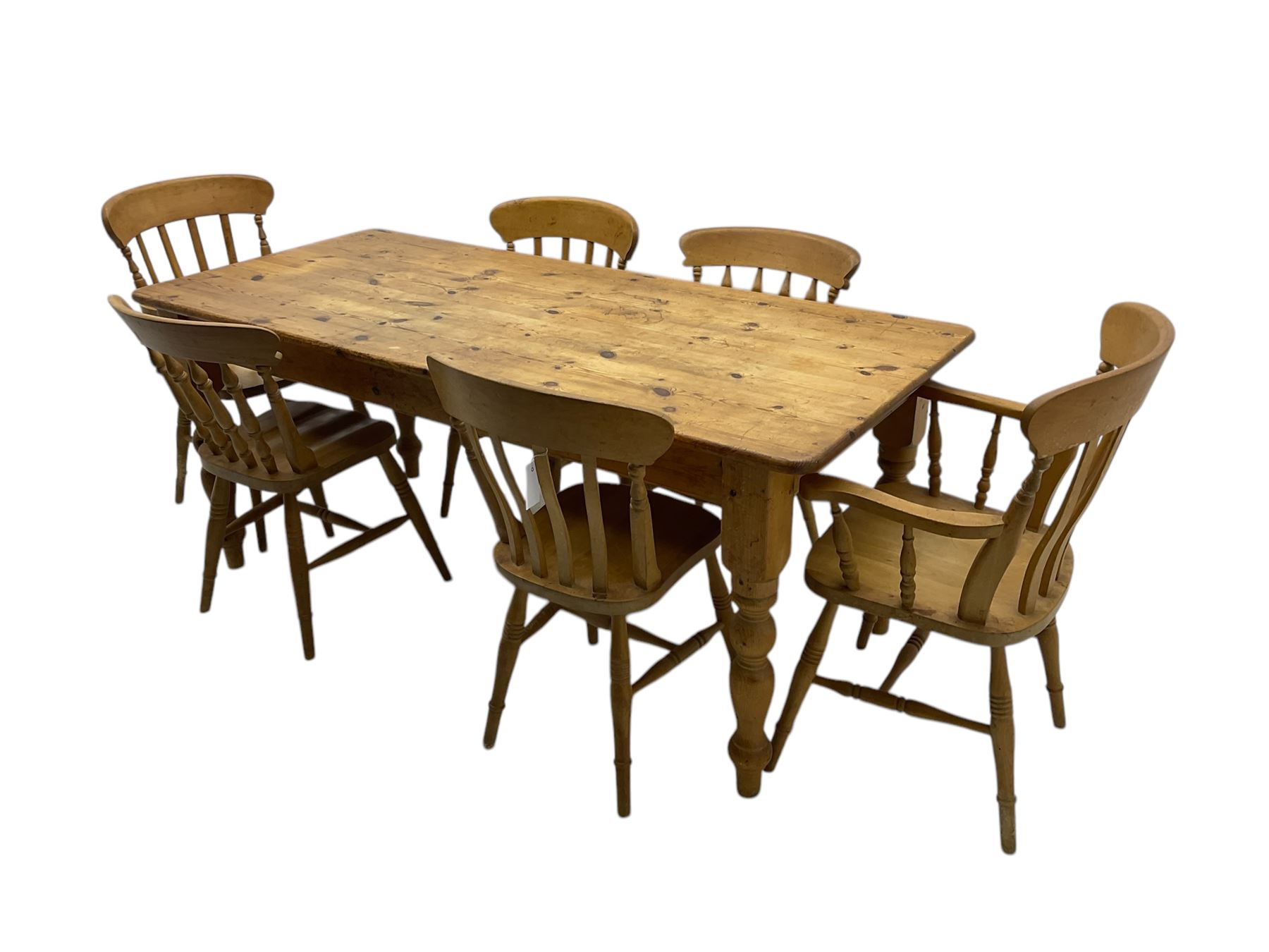 Pine farmhouse dining table, rectangular top with rounded corners, raised on turned supports; together with a set of six (4+2) spindle-back dining chairs