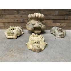 Four grotesque garden wall masks