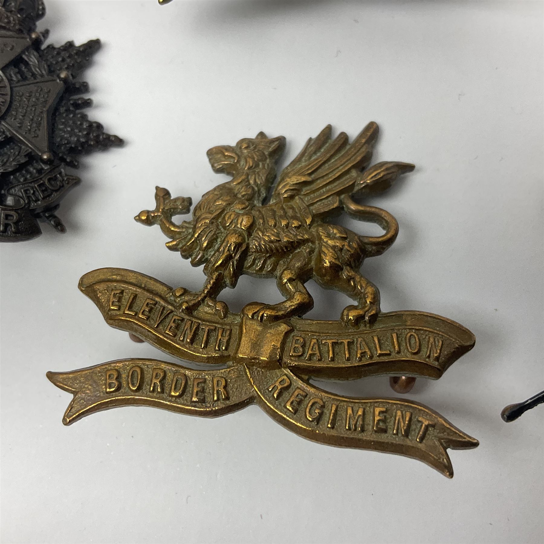 Four Border Regiment cap badges including eleventh battalion (4)