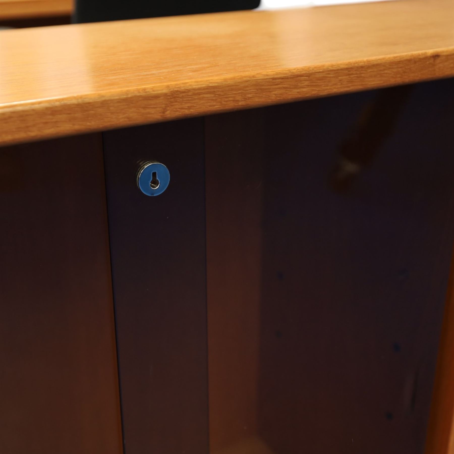 Light oak bookcase cabinet, fitted with four sliding tinted glass doors