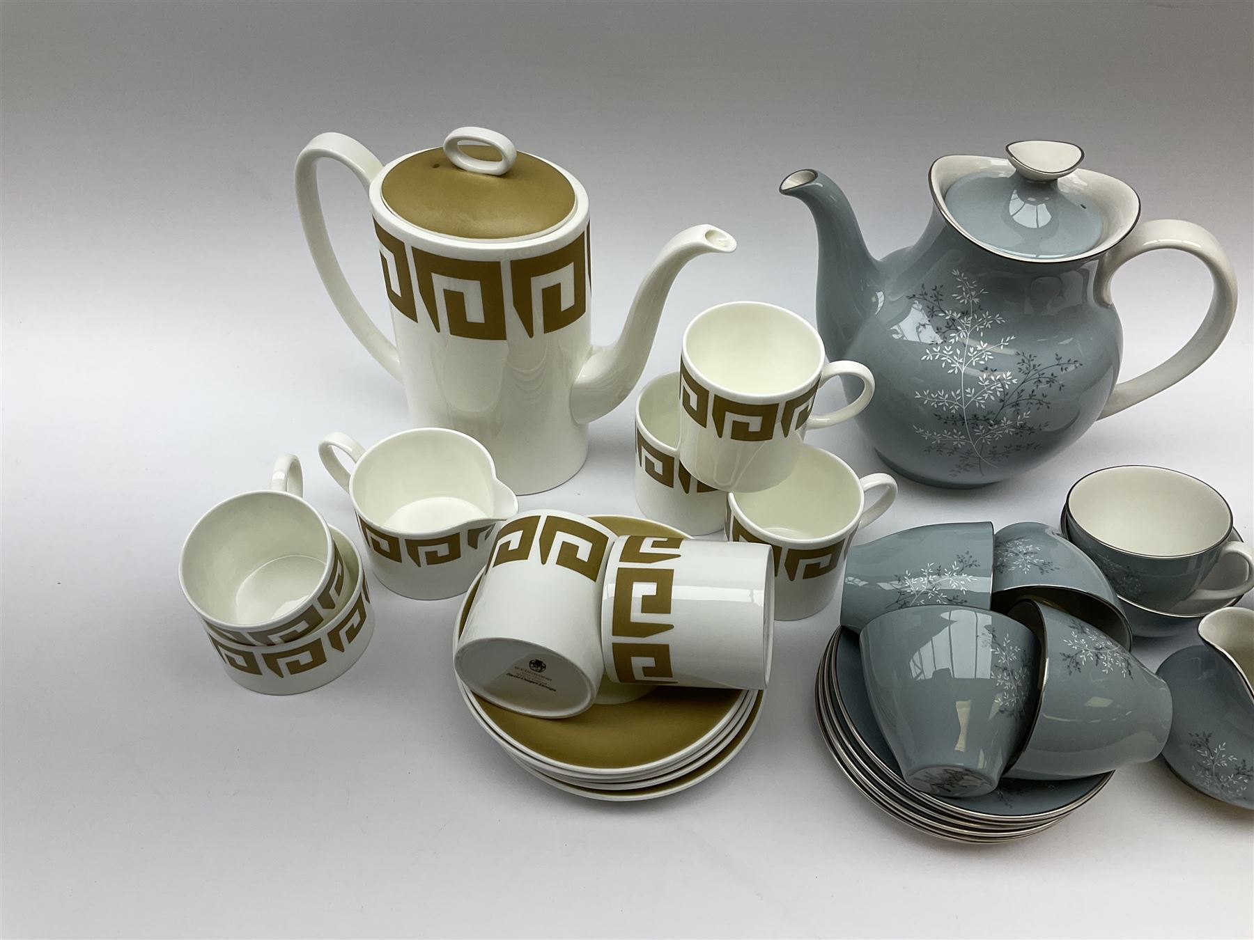 Royal Doulton Forest Glade pattern tea set, comprising teapot, milk jug, open sucrier, six cups and saucers, together with a Wedgwood Susie Cooper tea set, with Greek key decoration, comprising coffee pot, six cups and five saucers, open sucrier and milk jug.