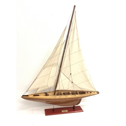 Bespoke Oak Furniture model of a 1930s J Class Americas Cup Challenger sailing yacht with mahogany hull, simulated planked deck with various fittings and three sails, on integral stand with plaque 'Shamrock 1930', L80cm H101cm