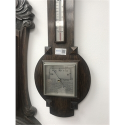 Early 20th century oak cased aneroid barometer with thermometer and another early 20th century oak cased barometer with carved detail