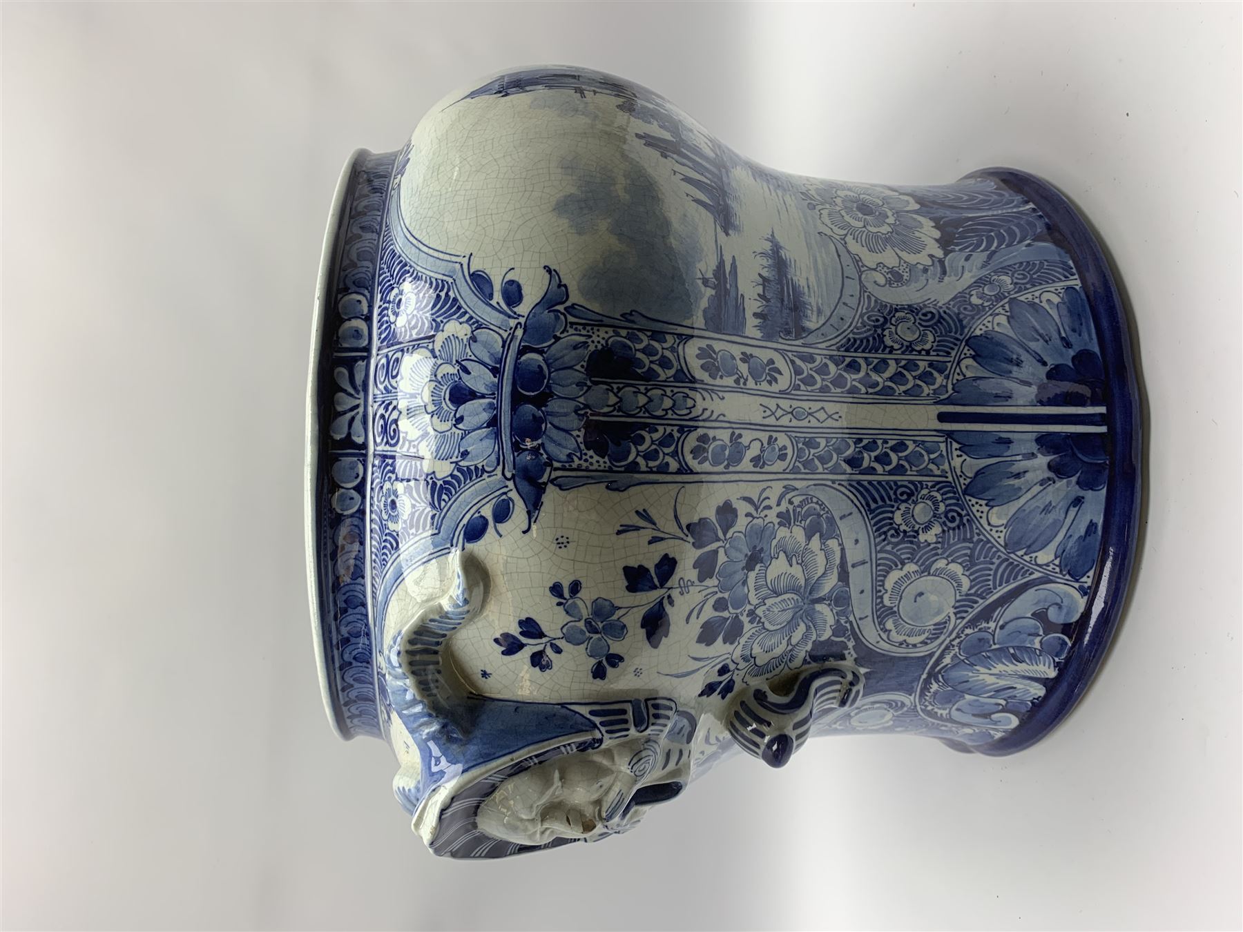 Large 20th century Delft blue and white jardinière, of baluster form with twin zoomorphic mask lug handles, decorated with hand painted panels of waterside scenes, within foliate surround, impressed and painted marks beneath for De Porceleyne Fles workshop, Delft, H35cm, rim D32
