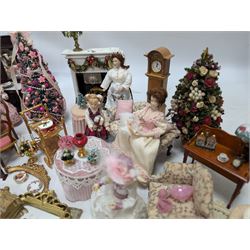 Dolls house living room and ding room furniture, including sofa, chair, long case clock, Christmas trees, fireplace, dresser, chairs, tables, mirrors, seven figures and a collection of predominantly Christmas themed decorations, food, etc