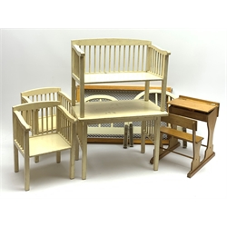 Tri-ang doll's bed with white painted head and footboard and spring base L50cm; doll's white painted wooden four-piece dining suite; and doll's school type wooden combined desk and chair with satchel of stationery items etc