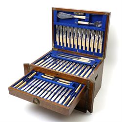 Suite of plated table cutlery for twelve covers including fish cutlery and servers, fruit knives and forks with mother of pearl handles, bone handled knives, carvers etc in an oak  three drawer cabinet with hinged lid W47cm 160 pieces
