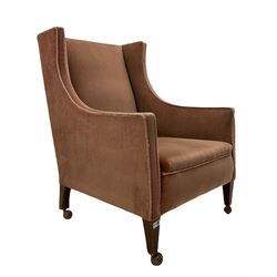Edwardian wingback armchair, on square tapering supports