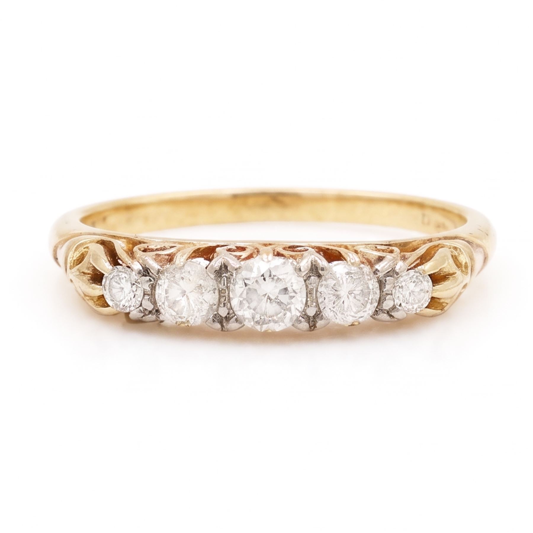 Early 20th century gold diamond ring, set with five graduating old cut diamonds, with scroll design gallery, stamped 18ct, total diamond weight approx 0.30 carat