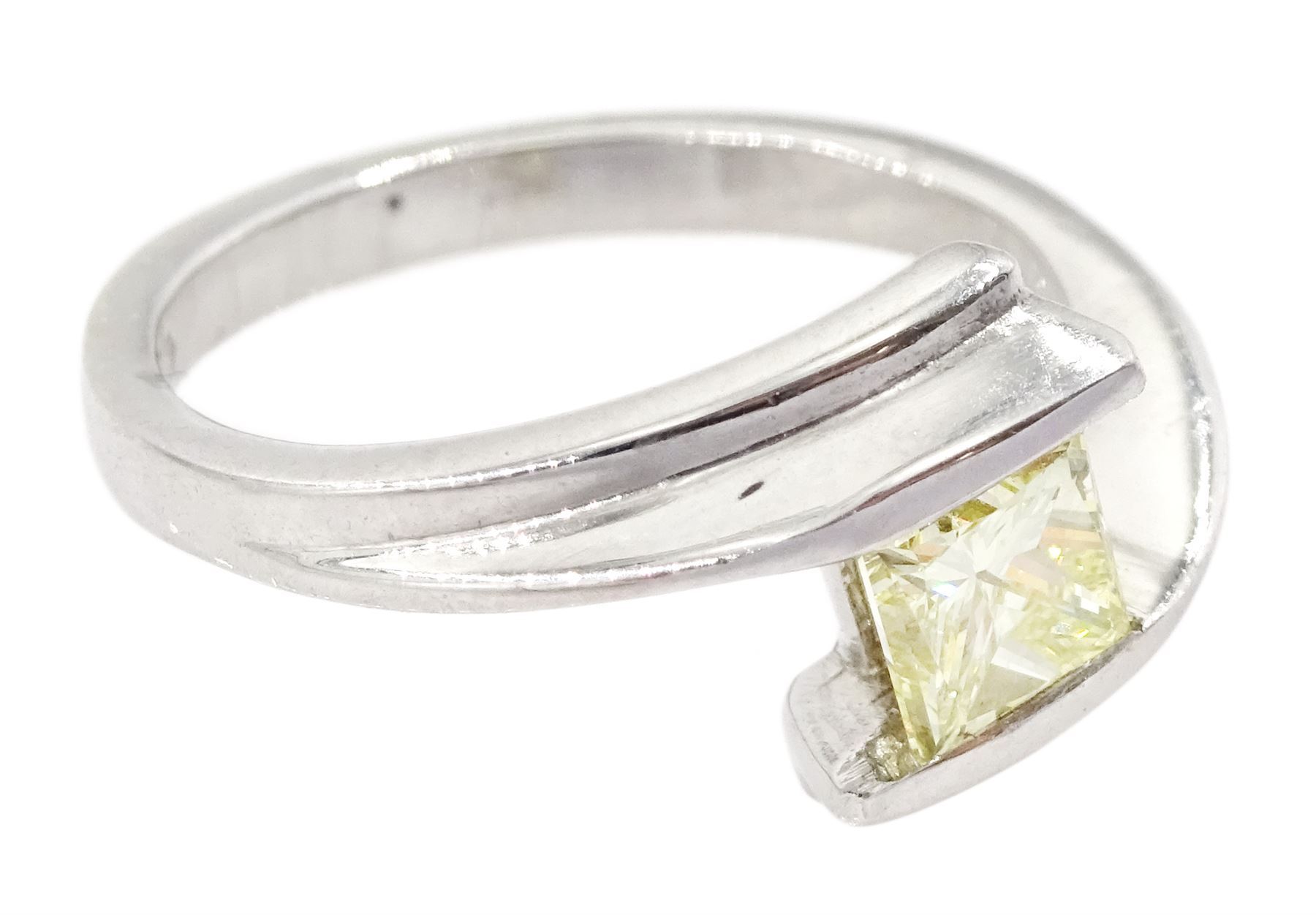 Platinum diamond ring, tension set with a single princess cut fancy yellow diamond of approx 0.60 carat, hallmarked