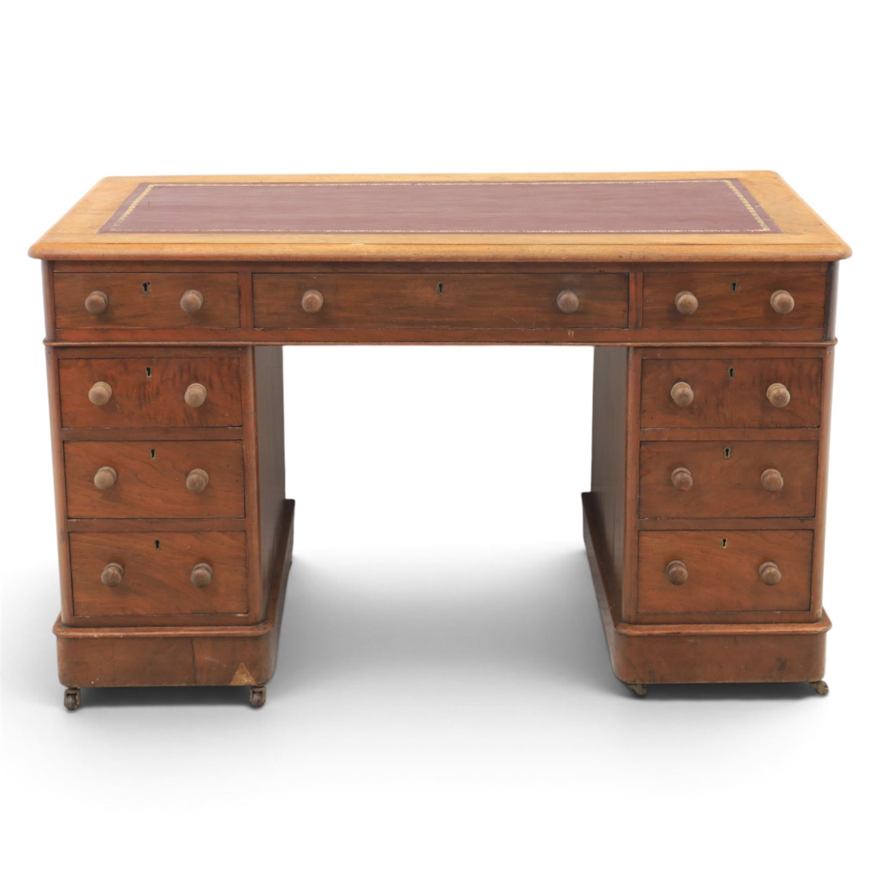 Victorian mahogany twin pedestal desk, rectangular top with red tooled leather writing surface with three frieze drawers, each pedestal with three drawers and castors