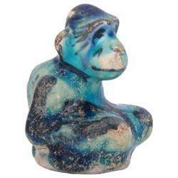Raqqa ware pottery model of a monkey, probably Assyrian, modelled in crouching position, with turquoise and blue glaze, H6cm, together with a Raqqa ware pottery pot, also probably Assyrian, of square sided form, twin lug handles and canted cover, upon four tapering feet, decorated with yellow and green zig-zag bands upon a turquoise glazed ground, H8cm