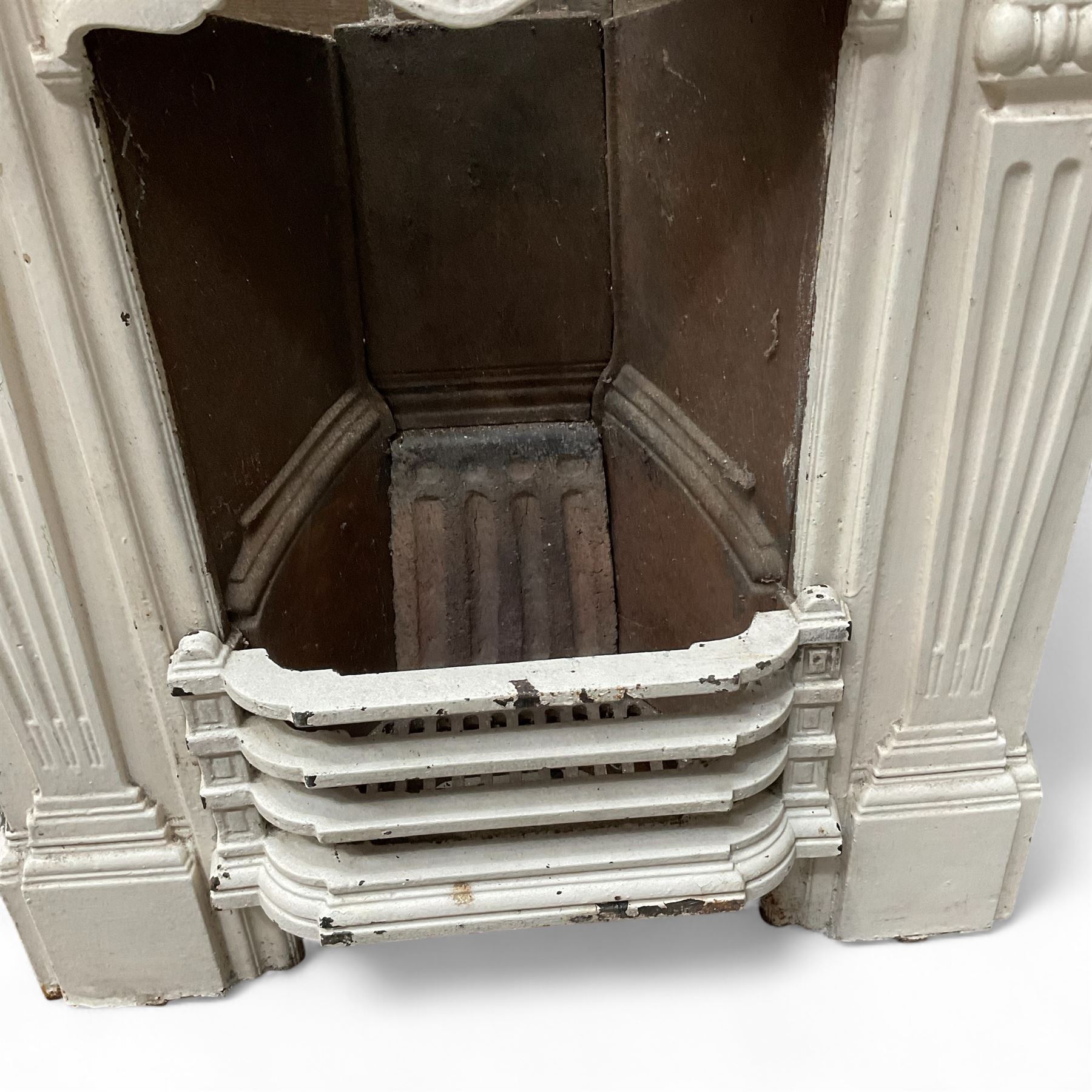 Two Victorian small cast iron fireplaces in a white finish