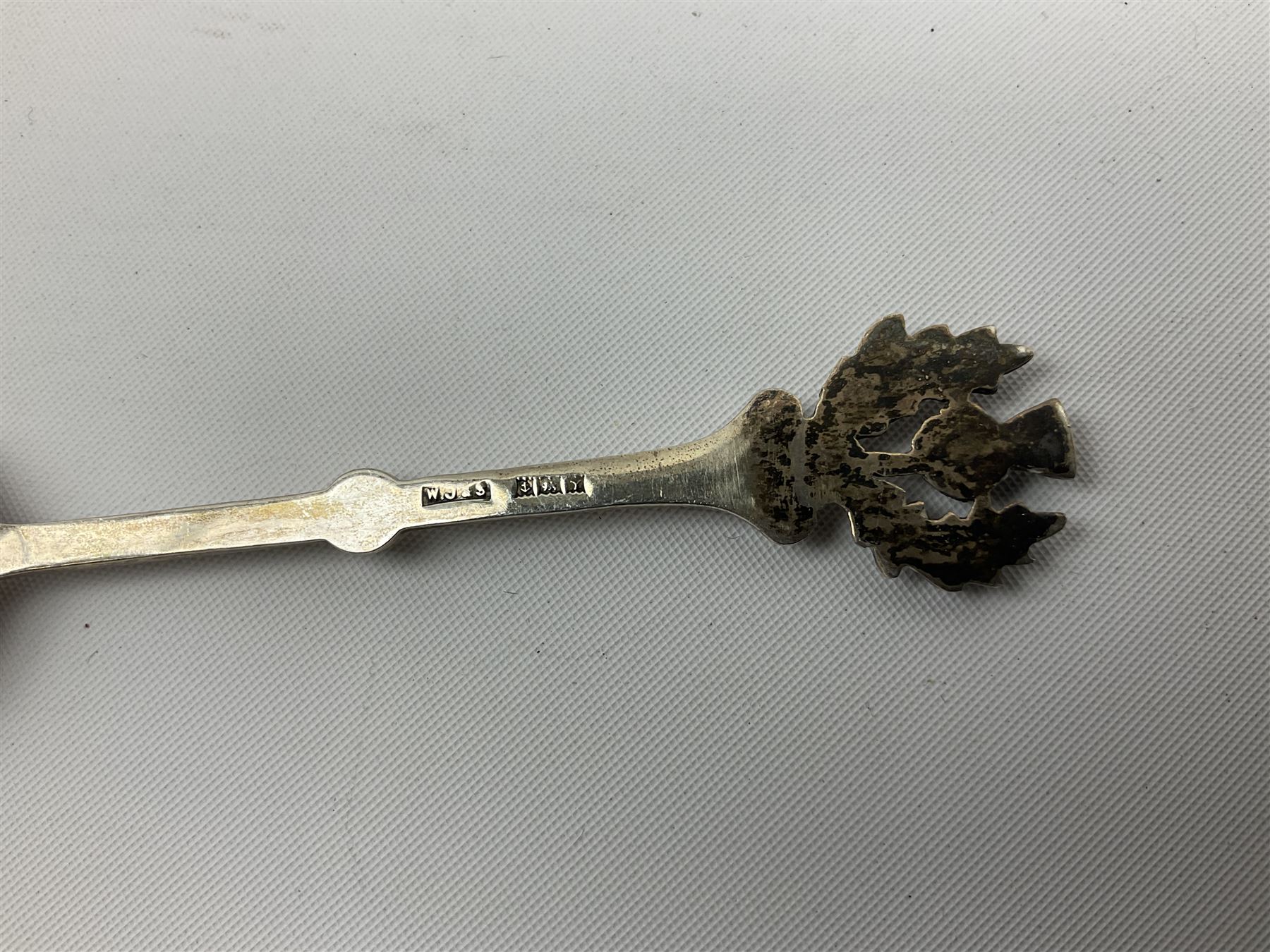 Two silver napkin rings, silver spoon with thistle top terminal, two silver handled butter knives, and small glass jar with silver cover, all hallmarked, approximate weighable silver 53.7 grams