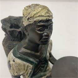 Bronze figure of a seated man resting on a sack