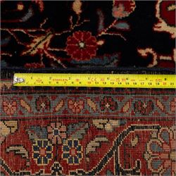 Two hand-knotted rugs, comprising Persian floral rug, dark blue ground decorated with scrolling foliage and flowerheads within a red floral border (H 208cm, W 134cm); Bokhara type rug, red ground with repeating gul motifs and geometric guard borders (H 174cm, W 94cm)