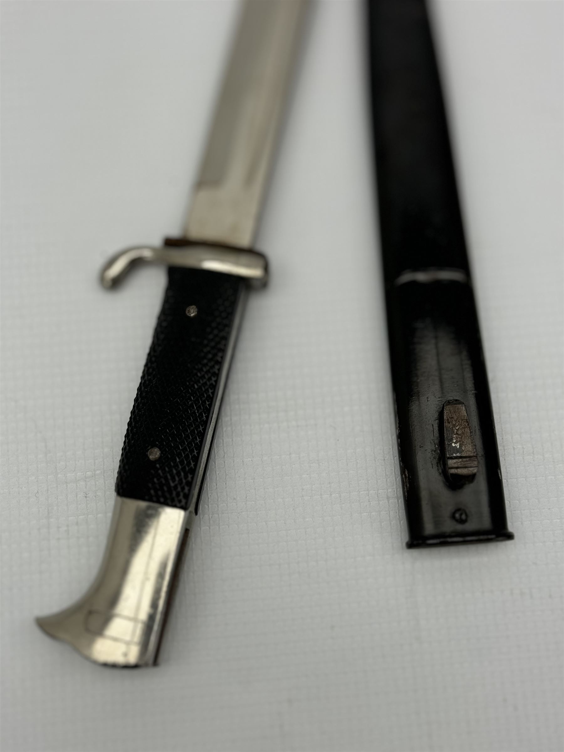 German Third Reich bayonet, the steel blade stamped E & F Horster, Solingen with black plastic chequered grip scales, L35cm