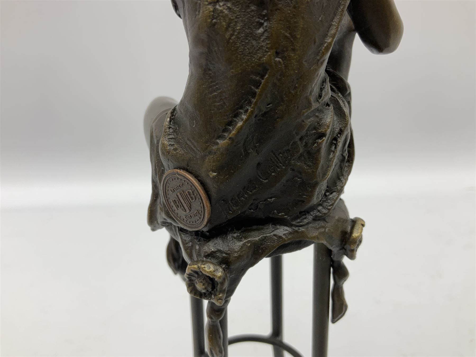 Art Deco style bronze modelled as a female figure, holding her knee, seated upon a chair, after 'Pierre Collinet', H28cm