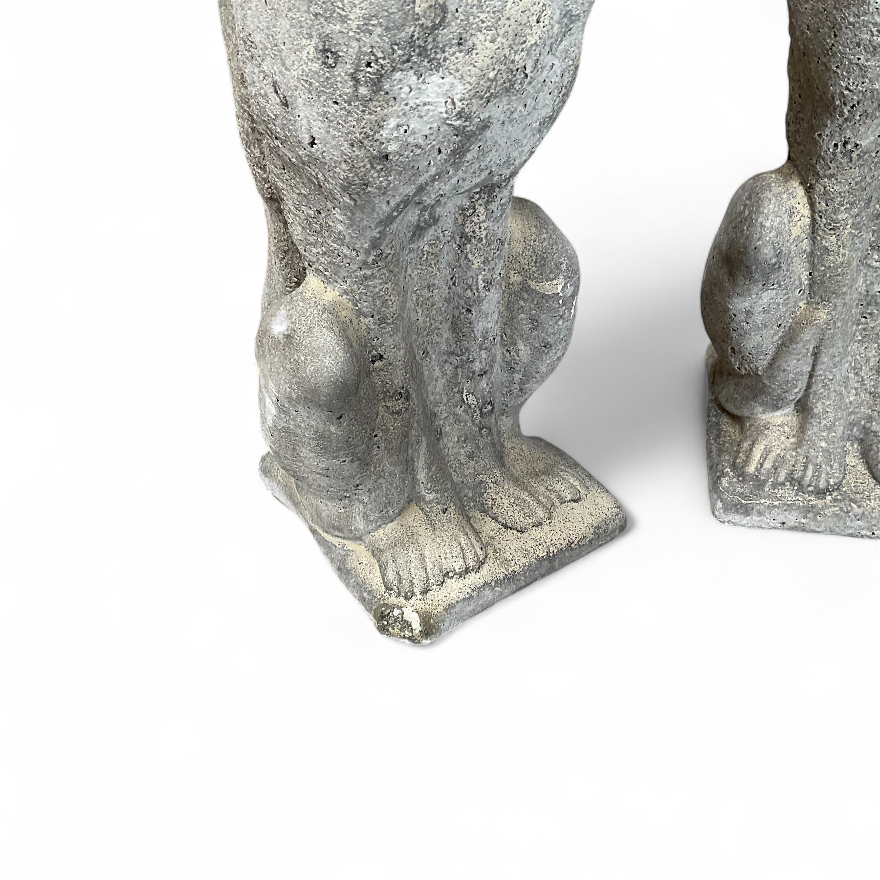 Pair of cast stone sitting greyhounds 