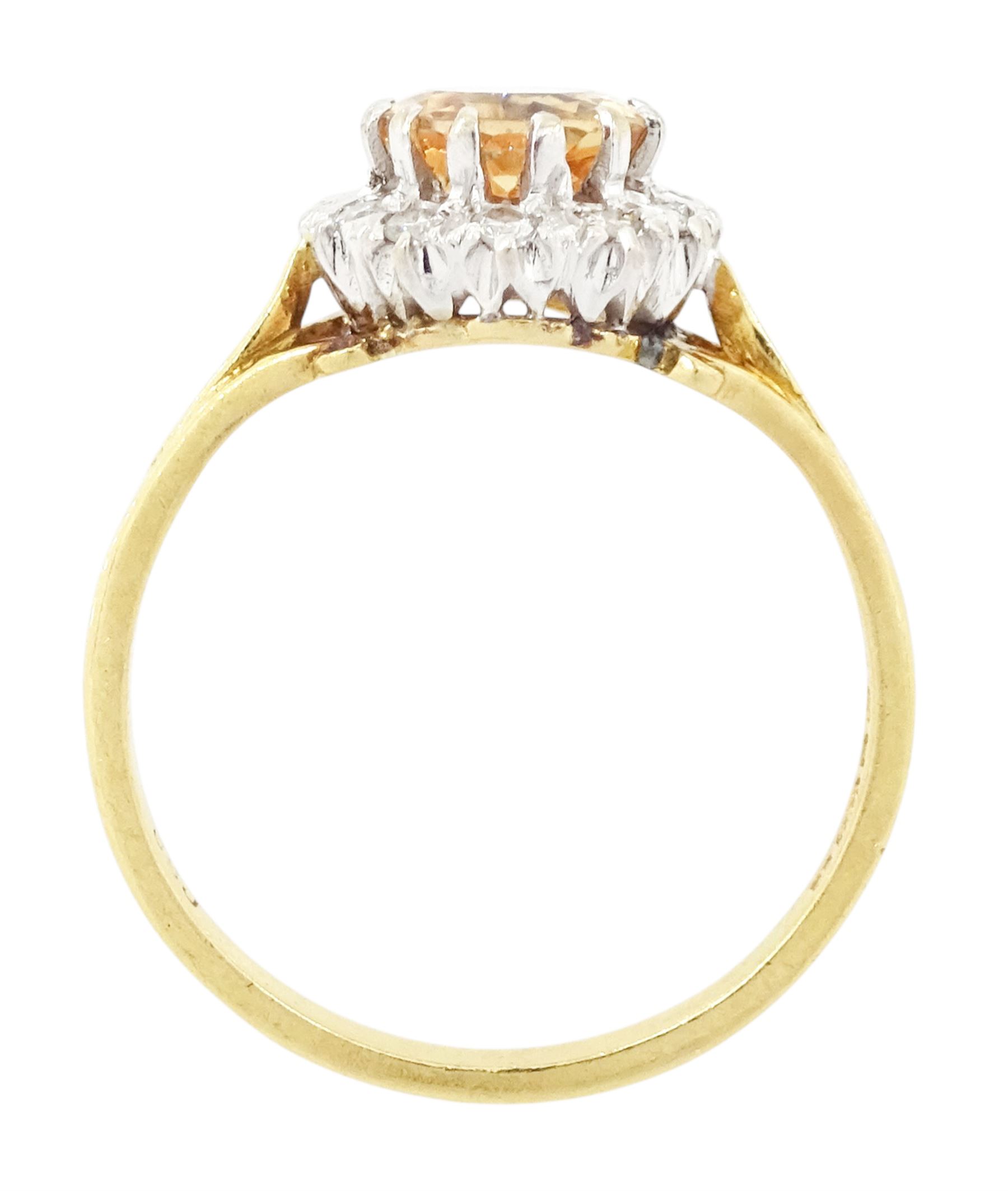 18ct gold imperial topaz and diamond cluster ring, oval cut topaz of approx 1.50 carat, surrounded by twelve round brilliant cut diamonds, London 1987, total diamond weight approx 0.10 carat
