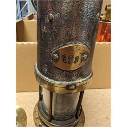 Miners lamp, with plaque numbered 173, together with a miniature brass miners lamp and a wooden paperweight with applied brass miners lamp, pick axe and shovel