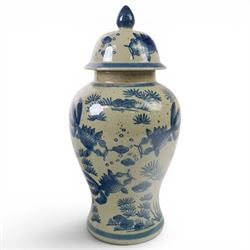 Pair of Chinese blue and white jars and covers, of baluster form, painted with fish and foliage H36cm