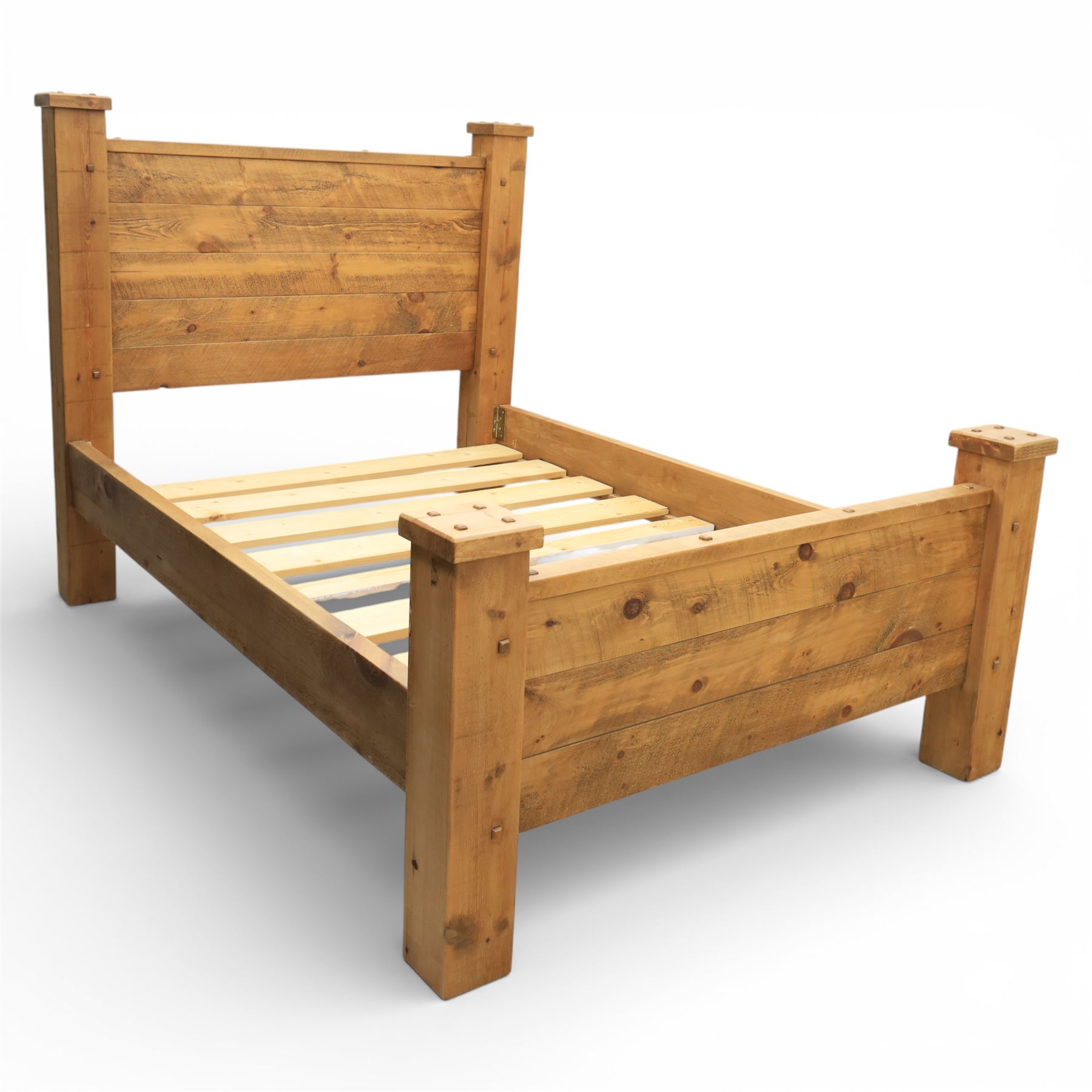 Alexander Ellis of Beverley - rustic pine king sized bed, of plank form construction with visible dowels, raised on stile supports