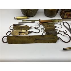Quantity of brass suspension scales, grease guns, hunting horn, plaques, two jam pans, iron sugar cutter, bullet moulds, nut crackers etc; and 19th century cannon ball 