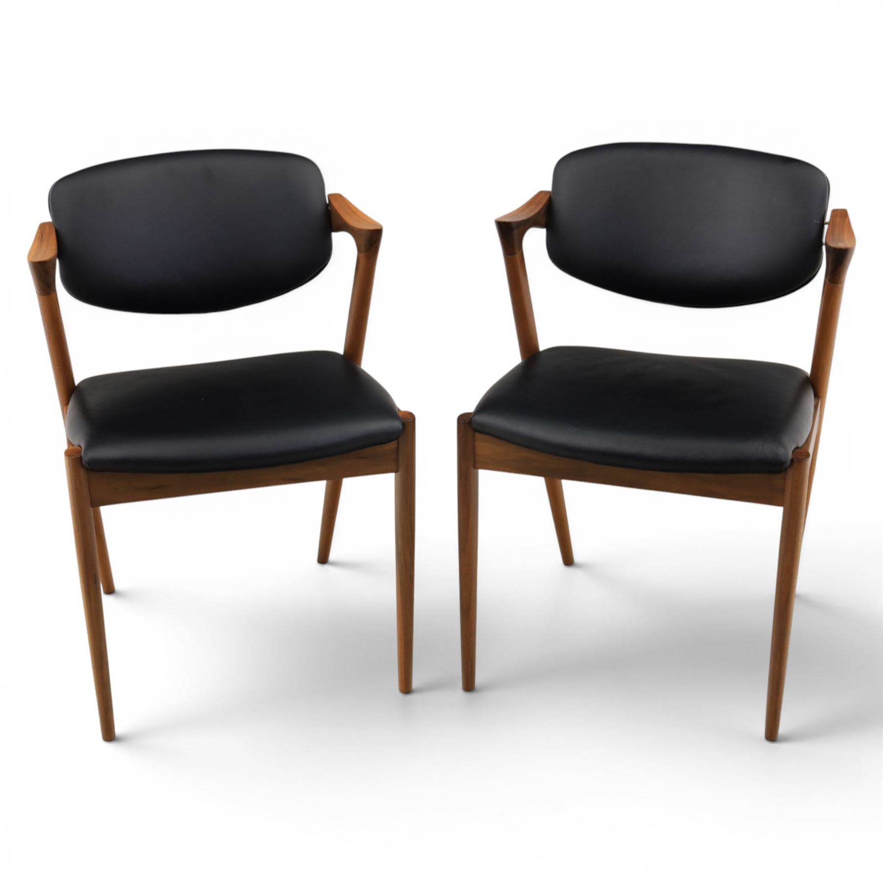Kai Kristiansen (Danish c.1929-2022) - Pair of mid-20th century teak elbow chairs upholstered in black leatherette