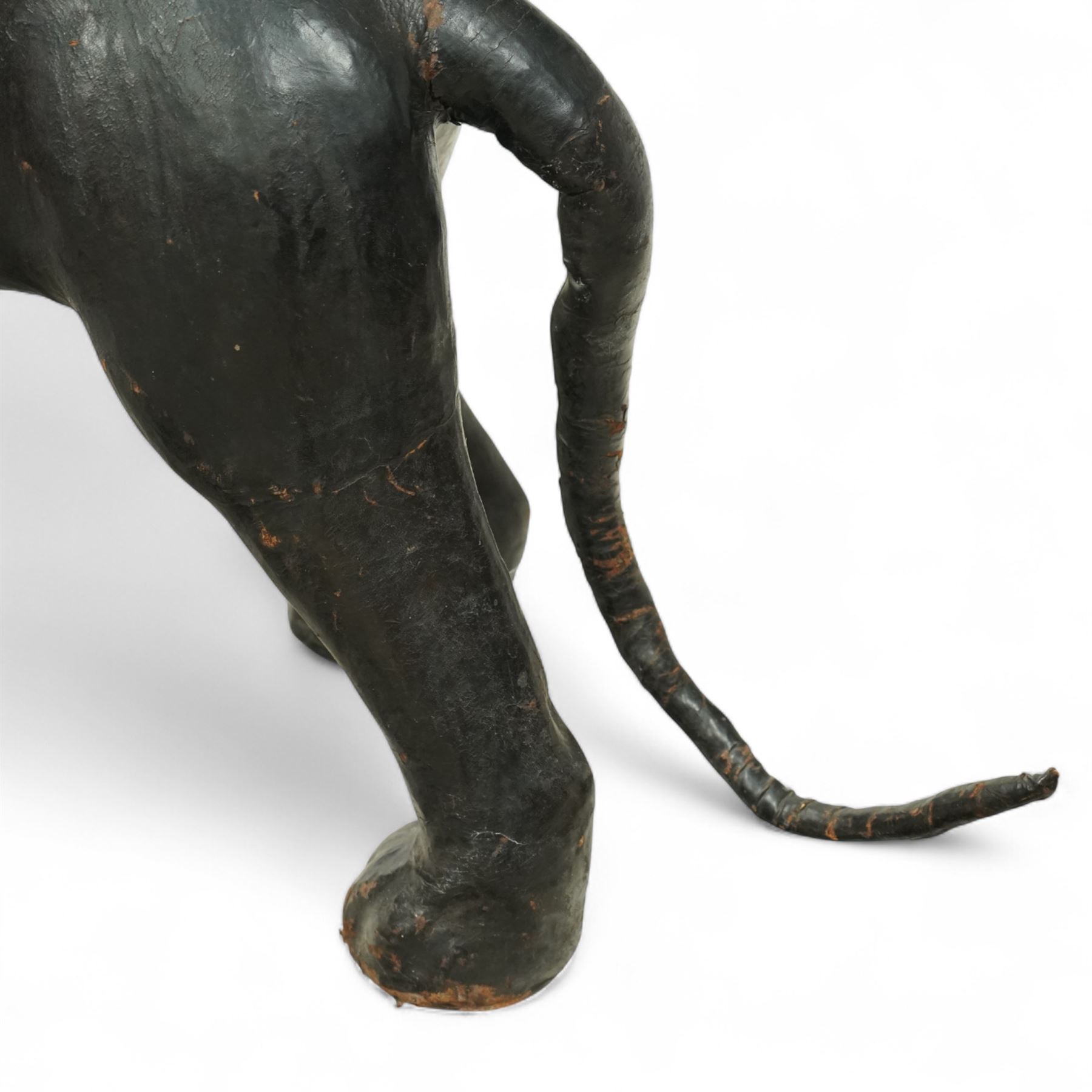Early 20th century leather-covered decorative model of a Panther in a naturalistic stance, prowling forward with arched back, lowered head, and extended tail, open jaws revealing teeth and fangs with nylon whiskers