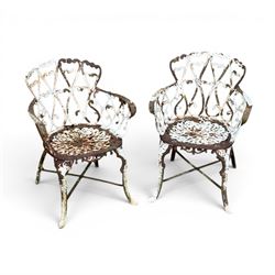 Pair of late 19th century painted cast iron garden chairs, open scroll and heart backs, ornate circular seat, raised on cabriole legs with X stretcher