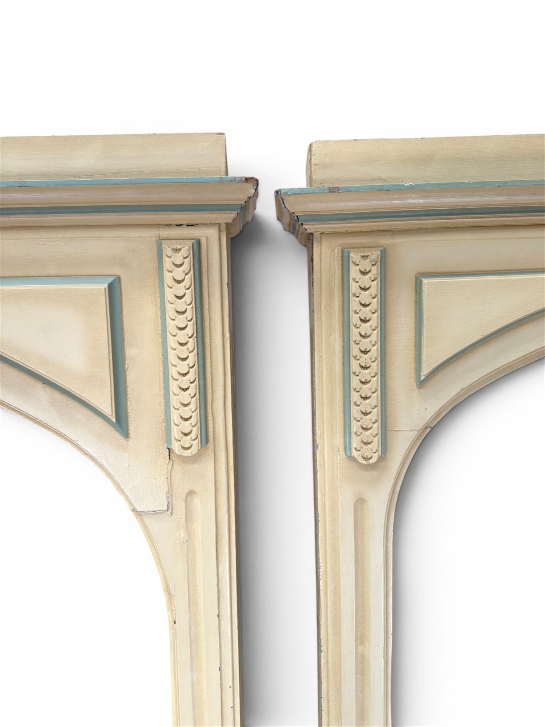 Two large painted pine window or door surrounds, square cornice with arch top, applied mouldings (widths 180cm and 130cm)