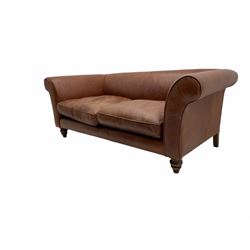 Two seat sofa, upholstered in tan leather, turned walnut feet