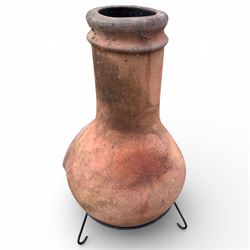 Terracotta chimney patio heater on metal stand