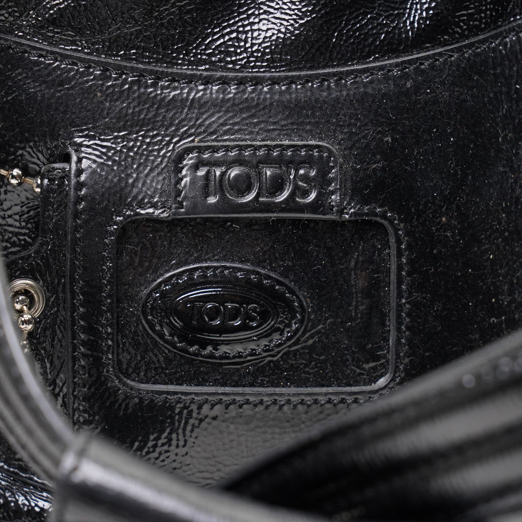 Tod’s - Tote Madis handbag in black patent leather, with twin rolled top handles, contrasting pale piping, silver-tone hardware, embossed Tod’s branding and hanging leather tag with ball-chain detail, with original Tod’s product tag and dust bag