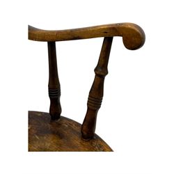 Late 19th century elm and beech Windsor rocking chair, with shaped top rail over turned spindles and curved arms, circular seat raised on turned legs united by stretcher on rockers