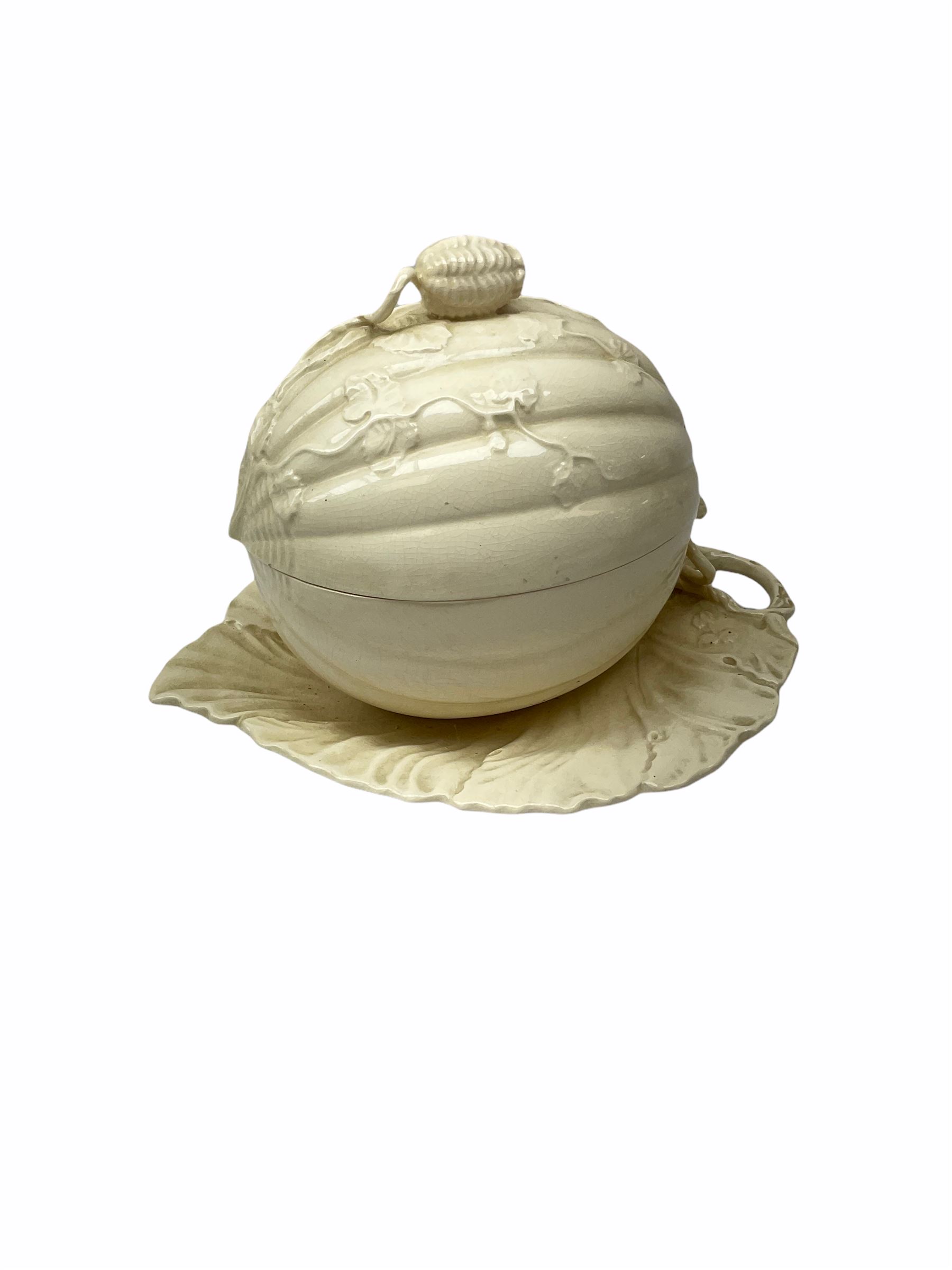 20th century Leeds creamware, comprising chestnut basket and stand, small tureen and cover, ladle, and associated stand, candlestick with stem modelled as a dolphin, teapot, tureen and cover in the form of a melon with fixed stand, and toast rack (toast rack a/f), each with impressed mark beneath. 