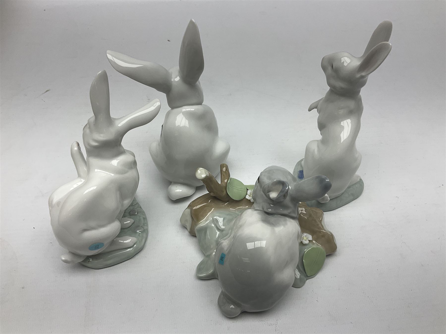 Four Lladro rabbit figures, comprising, Hippity Hop no 5886, Sitting Bunny no 5907, Washing up no 5887, and Rabbit Eating no 4773, largest example 14cm  