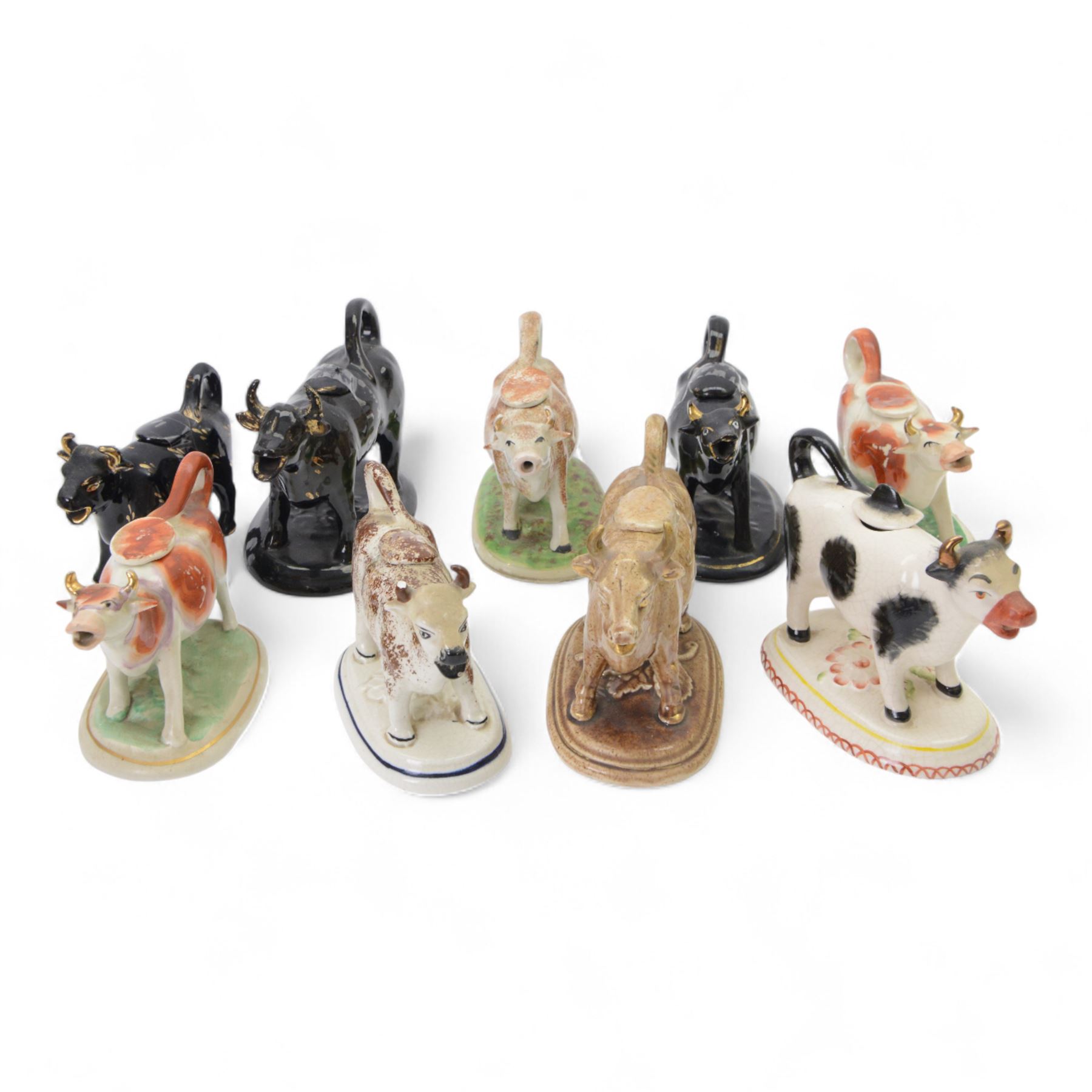 Collection of 19th century and later cow creamers, including three black glaze examples, two mottled brown examples etc  
