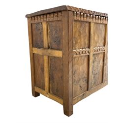 Gnomeman - oak blanket box, all-over adzing, the hinged top over figured and burr panelled front, decorated with carved crenellations and arcade, carved with gnome signature, pierced handles to each end forming the central rail, wrought metal hinges, on stile supports, by Tom Whittaker, Littlebeck, Whitby