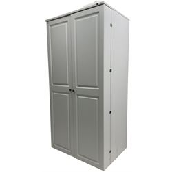 Large white finish sewing cabinet, enclosed by two doors fitted with thread holders and shelves, the interior fitted with shelves and sliding trays, with fold down work surfaces 