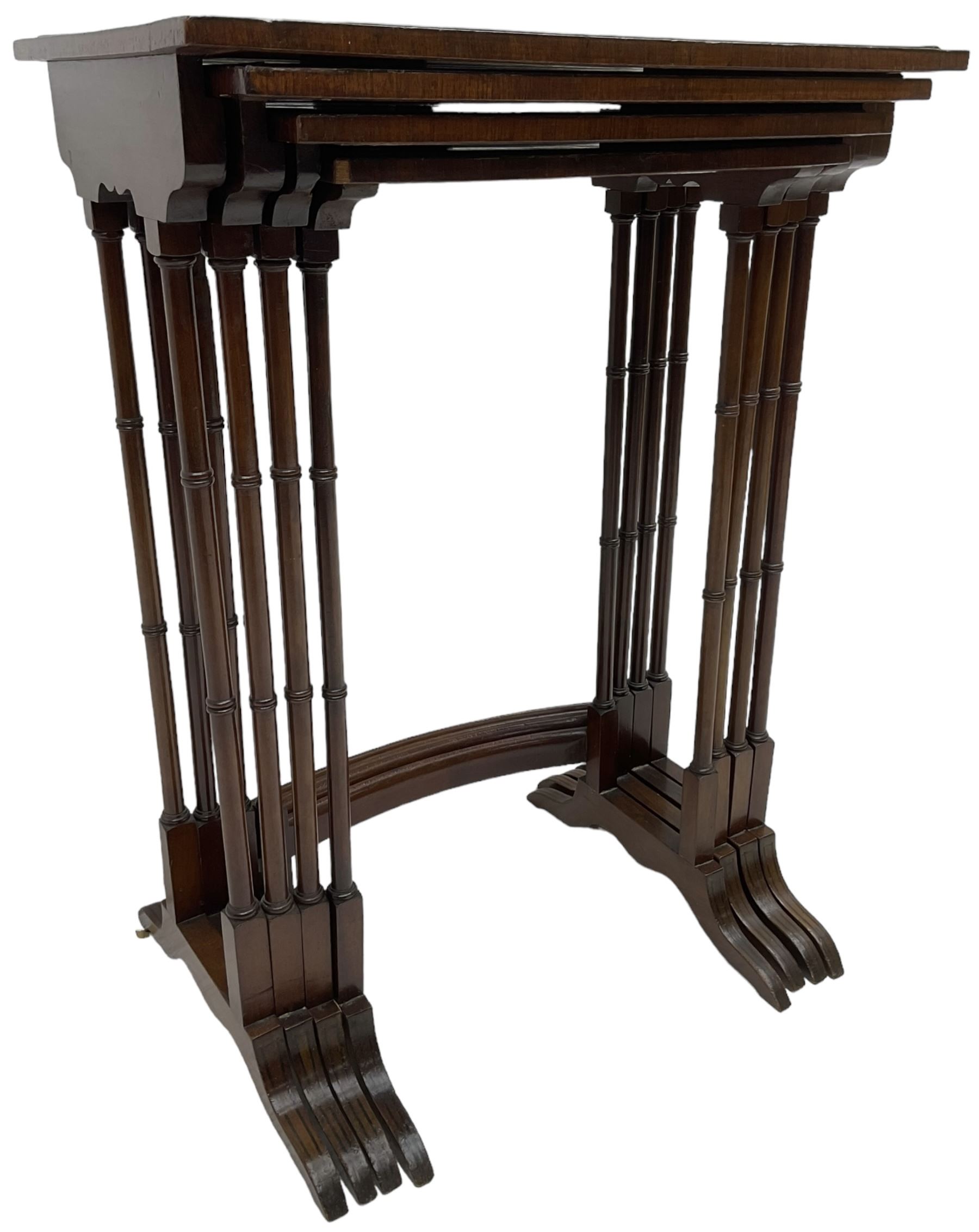 20th century inlaid mahogany quartetto nest of four tables, rectangular top inlaid with birdseye maple oval panel, ring turned supports on sledge feet