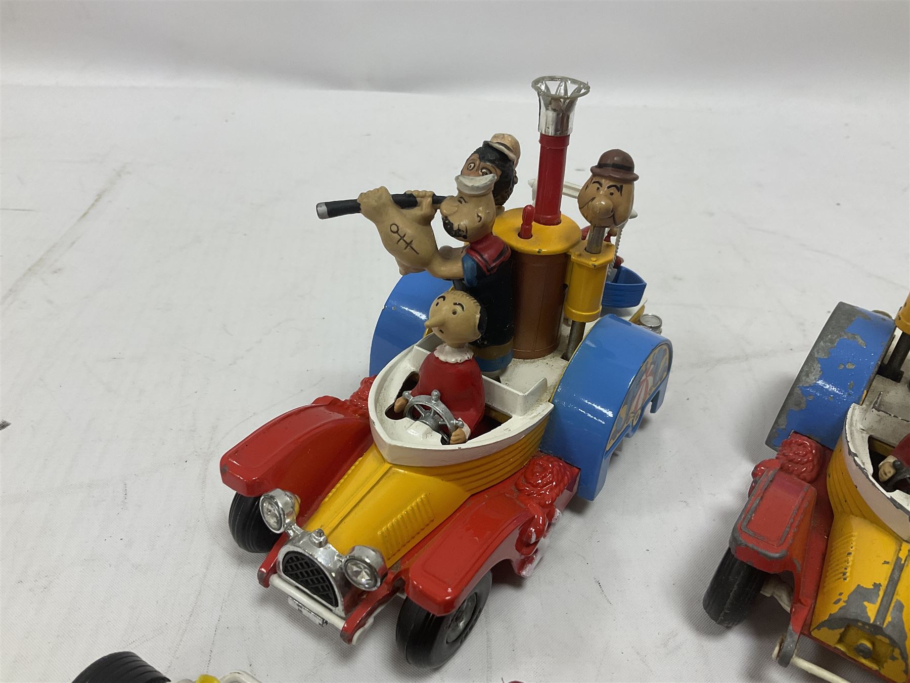 Corgi - ten unboxed and playworn TV/Film related die-cast models including three Popeye Paddle Wagons; Dick Dastardly; Magic Roundabout; Muppets; Batman Penguinmobile; and Basil Brush (10)
