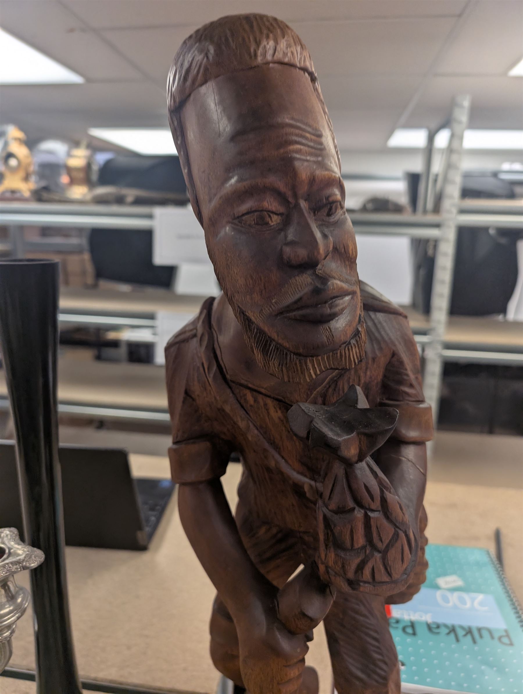 Carved wooden figure of a man holding a pineapple, together with a silver plated candelabrum, cut glass basket, etc, figure H64cm
