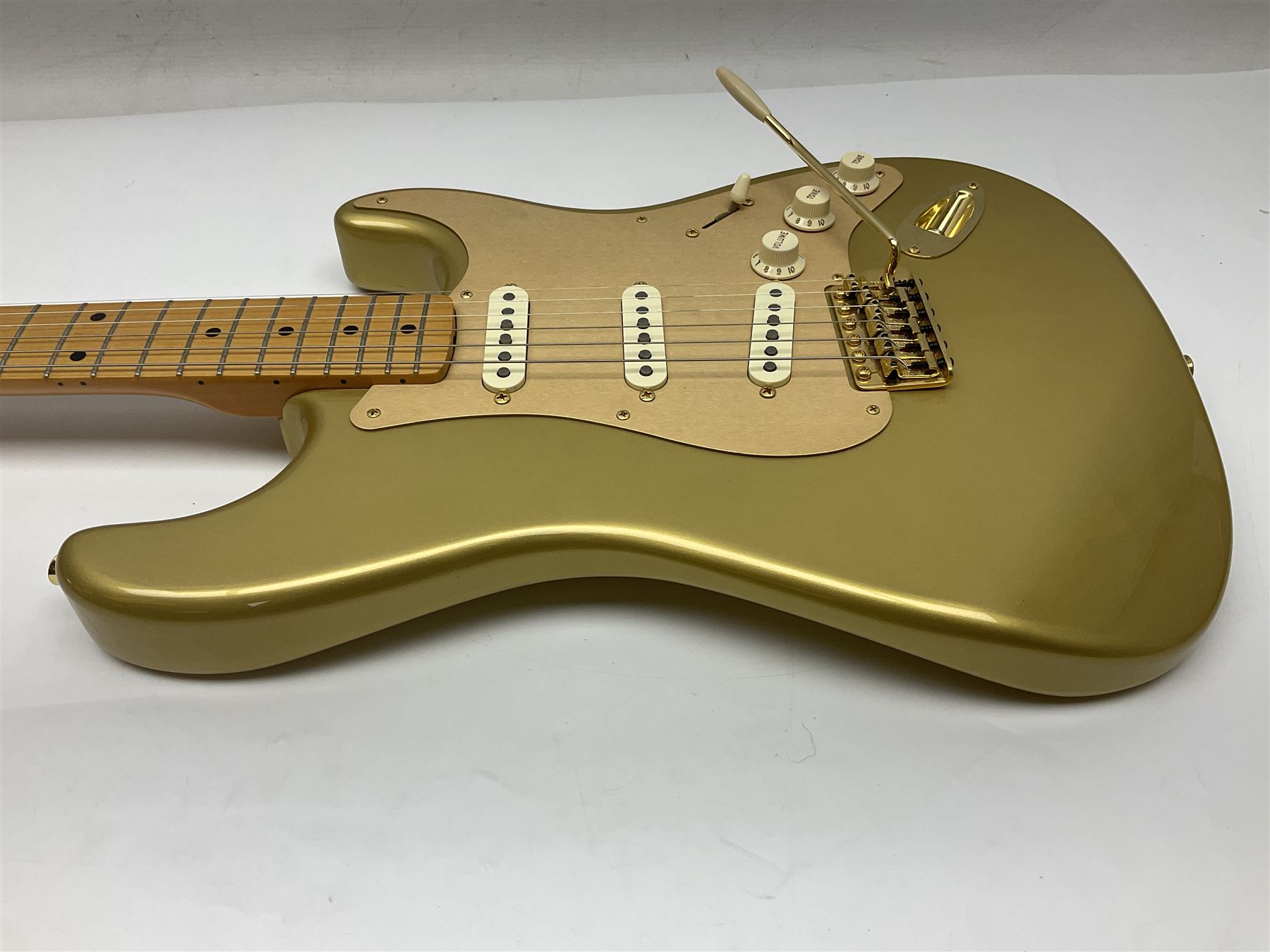 Fender Stratocaster 50th Anniversary 2004 metallic gold electric guitar; serial no.MZ4116369; L98cm; in Spider fitted case with owners manual and other paperwork, strap and belt buckle etc