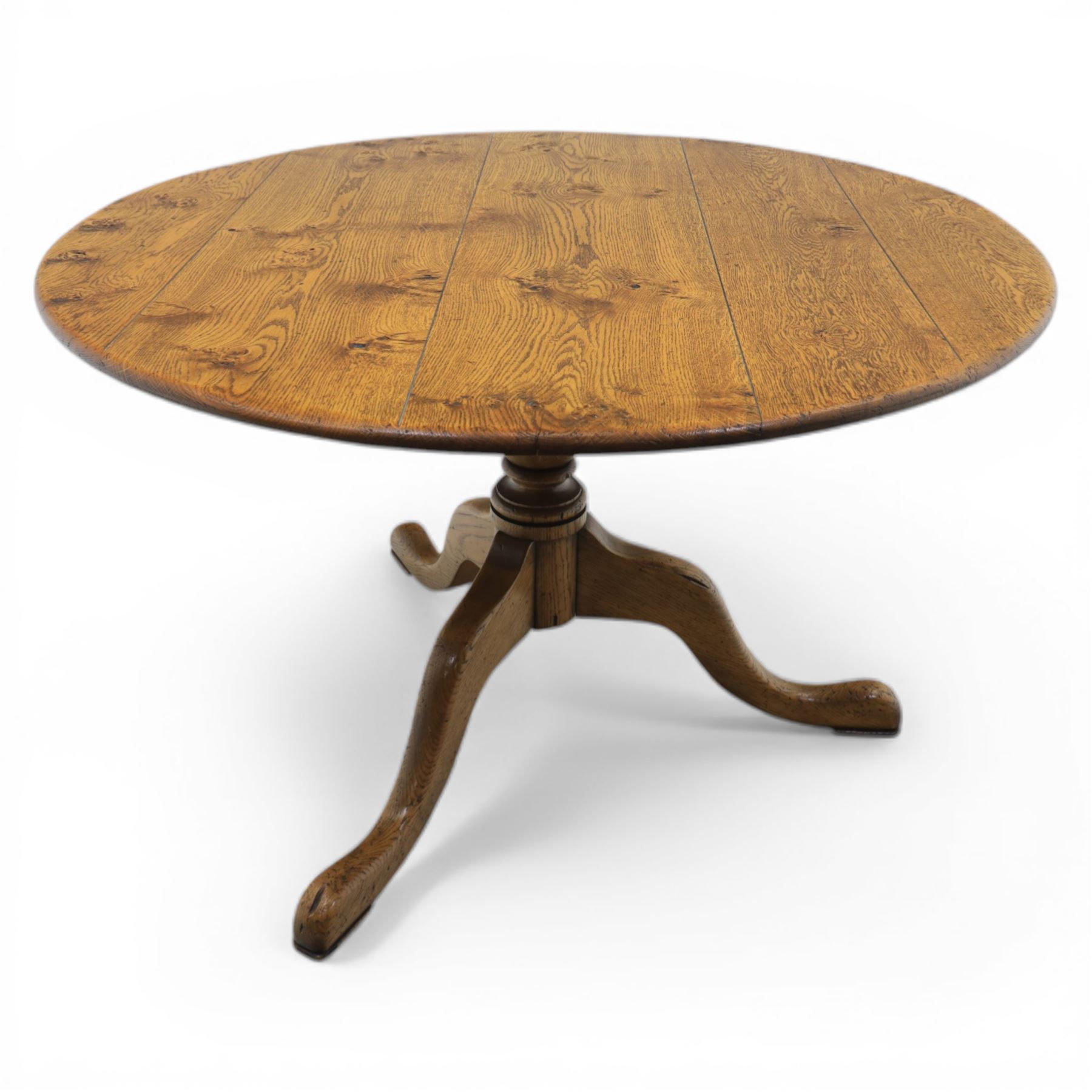 Traditional oak circular pedestal dining table, circular plank top, turned baluster column above three shaped legs