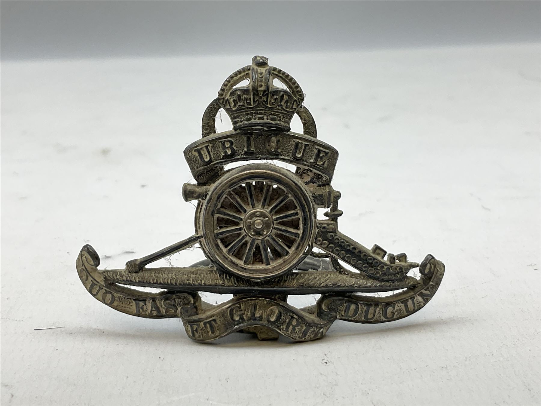 Trench Art - three WW2 brass shell case ashtrays, one mounted with Royal Artillery cap badge and button and one mounted with RA button; together with a pair of place name holders each formed from a Royal Artillery cap badge (5)