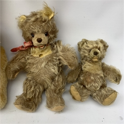  A group of four teddy bears, to include a small Steiff example with button to ear, and a Chad Valley example with label to foot, each with jointed limbs and glass eyes.   