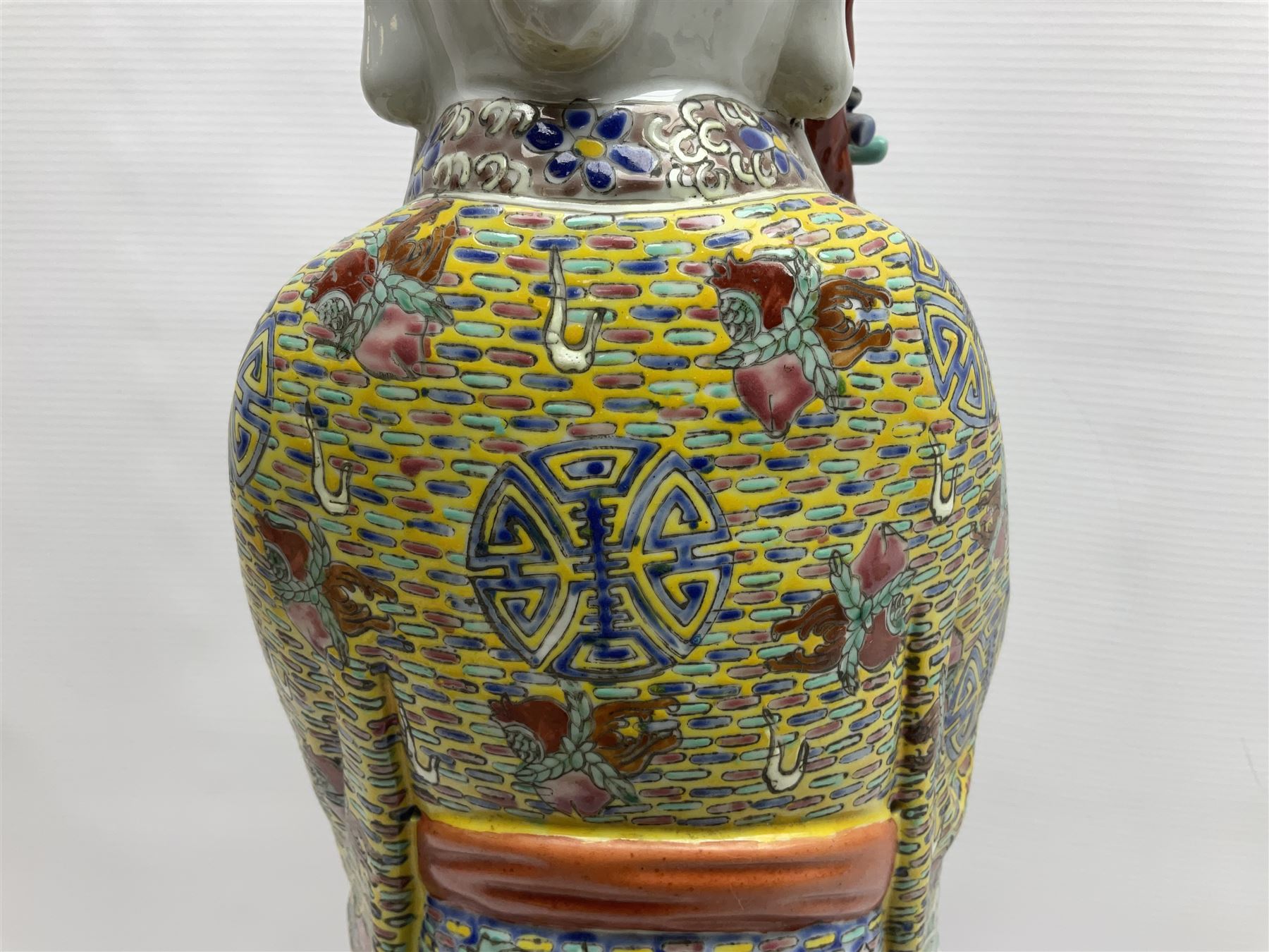 Chinese Republic Period porcelain figure, modelled as Shoulao, wearing elaborately enamelled robes decorated with peaches and flower heads, with impressed mark beneath, H55cm