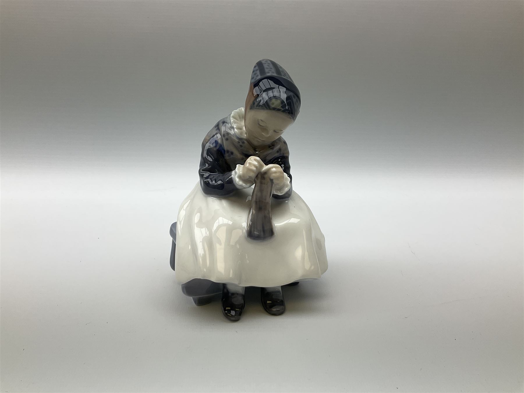 Three  Royal Copenhagen figures, girl knitting 1314, girl standing with a goose 527 and man in traditional Dutch clothing with hammer 620